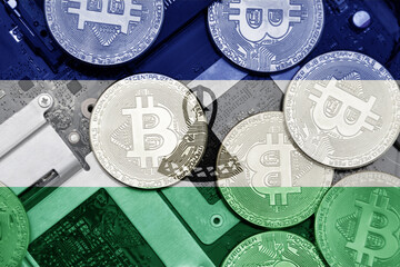 flag of lesotho on the bitcoins with computer electronic circuit board background. bitcoin concept.
