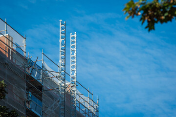 Scaffold sheeting net wrapped apartments building during insulation in england uk