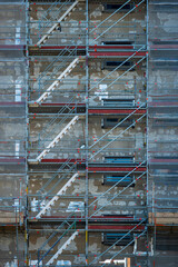 Scaffold sheeting net wrapped apartments building during insulation in england uk