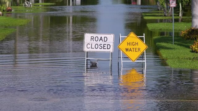 Hurricane Milton in Florida. Road under water warning sign. City street closed because of flooding danger blocking driving of cars
