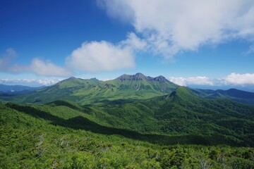 Breathtaking mountain vista under a clear blue sky in the heart of a lush green landscape