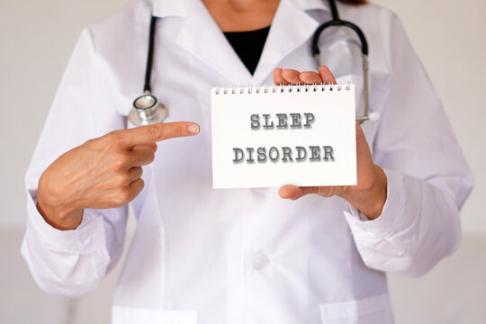 Sleep disorder concept. woman doctor pointing to words in a notebook