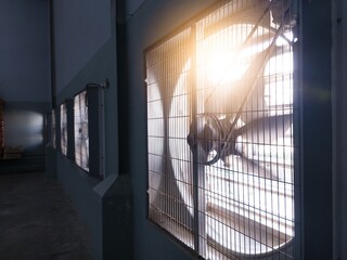 Big industrial Exhaust fan in a factory. Ventilation of plant building. With Shiny light.