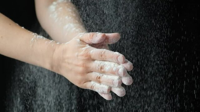Cook clapping his hands with flour, flour splash slow motion