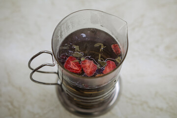 hot brewed tea in a French press. strawberry tea. autumn and health. hot healthy drink.