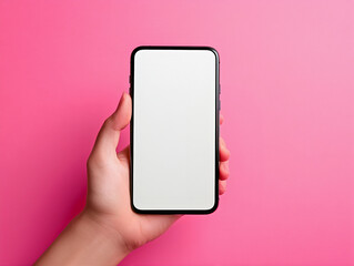hand holding phone with empty screen on pink background, front view