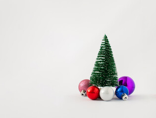 Christmas tree with multicolored decoration ormanents isolated on white background. Holiday concept.
