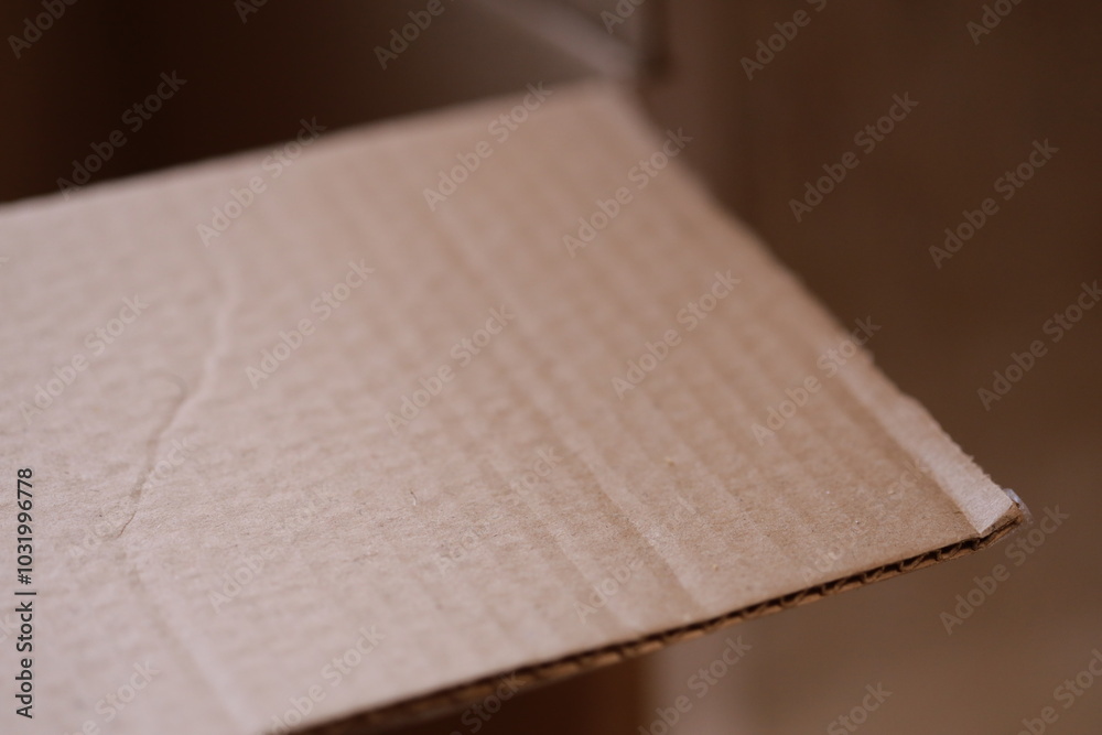 Poster close-up of a cardboard box on a table, suitable for e-commerce or packaging designs.