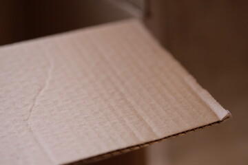Close-up of a cardboard box on a table, suitable for e-commerce or packaging designs.