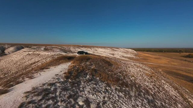 The camera flies low over the chalk mountains, there is no one around and a beautiful view from above.