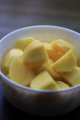 peeled potato pieces in a white plate.