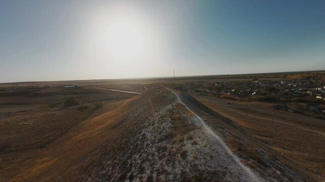 The camera flies low over the chalk mountains, there is no one around and a beautiful view from above.