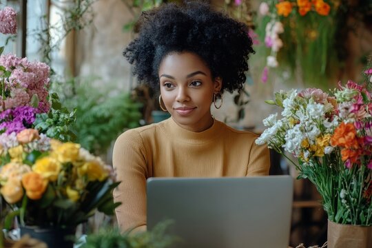 Starting floral business. Black female flower shop owner taking online customer orders, working on computer and using phone, sitting at cozy workplace, free, Generative AI