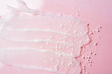 Cosmetic products on a pink background. Sample of enzyme powder and clear liquid cosmetics. Texture of cosmetic skin care product