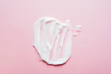 Sample of cosmetic cream on a pink background. Texture of cosmetic skin care product