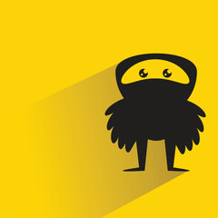 funny monster character with shadow on yellow background