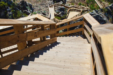 A detailed view of a wooden staircase with multiple platforms and railings