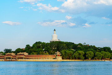 The iconic White Pagoda of Beihai Park at sunset under blue sky with white cloud in Beijing, China