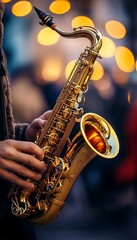 Obraz premium Close-up of a saxophone in golden evening light at a jazz concert, performance by a musician.