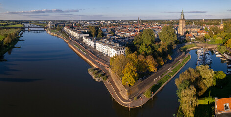 Aerial view of countenance against blue vibrant colourful sky with quay visible of river IJssel in...