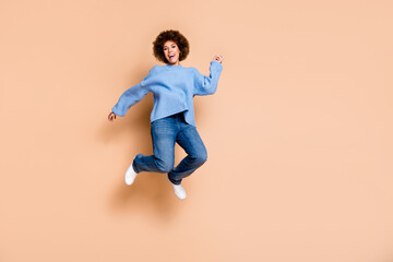 Full size photo of optimistic eccentric pretty girl dressed knit sweater jeans jumping having fun...