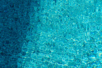 Glistening Turquoise Waters Reflecting Sunlight Create a Serene Atmosphere in a Tranquil Pool Setting During a Bright Summer Day