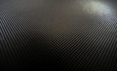 Rubber mat close-up. Futuristic black background with decorative honeycombs. Copy space.