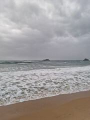 
This is a beach scene covered in dark clouds.