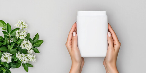 Obraz premium Sleek White Flexible Pouch Mockup with Two Female Hands Holding Rhodiola Rosea Flowers for Stress Relief and Skin Hydration