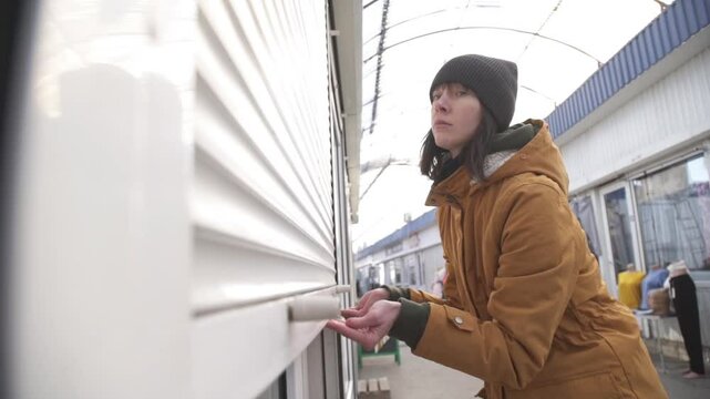 Female Business Owner of Local Store opening garage storefront
