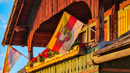 Traditional Austrian chalet in warm glow of setting sun on Lammersdorfer Alm, Milstatt, Carinthia,...