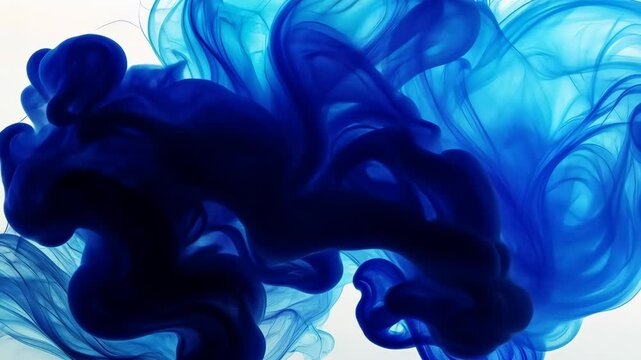 Abstract blue ink swirling in water, close-up artistic shot. Creative fluid art concept.