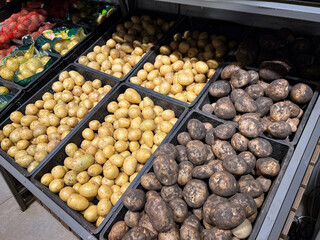 Potato. Shelf with potatoes in supermarket. Fresh organic potatoes for sale.