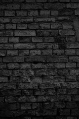 Old black brick wall tetxure. Grunge background