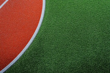 Close-up of a vibrant sports field featuring red and green artificial turf, ideal for athletic events and training facilities.