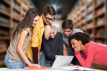 Happy young students learning at library for education