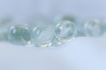 clear Glass marbles on a white background, close-up, selective focus