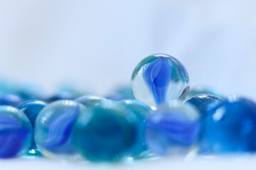 blue glass marbles on a white background close-up, macro photography