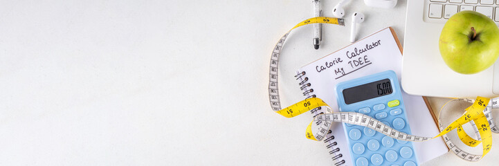 Calorie calculator, healthy TDEE concept. Calorie calculation based on total daily energy expenditure,  background with calculator, notebook, measuring tape, apple. Healthy weight loss diet background
