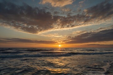 Obraz premium Serene Ocean Sunset with Vibrant Colors - Peaceful Waves and Dramatic Sky