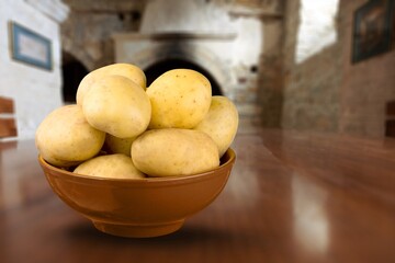 Young Fresh ripe potatoes vegetables on a wooden background.