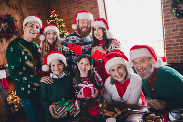 Fototapeta premium Portrait of peaceful big family embrace hold present enjoy celebrate new year xmas flat indoors