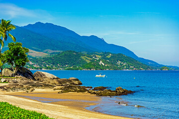 Beach in the urban area of ​​Ilhabela island surrounded by mountains and forests