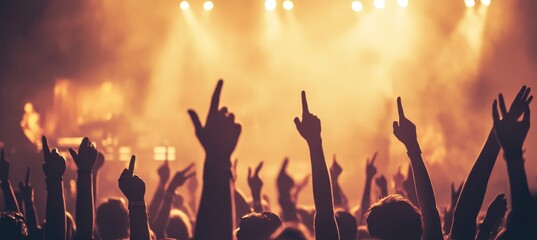 Silhouetted Crowd with Hands in Air at Concert, Illuminated Stage, Energetic Atmosphere