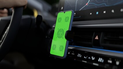 GREEN SCREEN CHROMA KEY A phone mounted on a car dashboard with a green screen, ideal for ride-hailing or navigation app mockups. Daytime, city setting, driving context