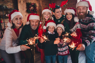 Portrait of friendly peaceful family smile hold bengal light stick gather celebrate new year xmas flat indoors