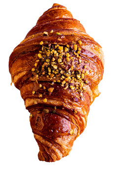 Un exquisito croissant relleno de crema de pistacho, con una textura crujiente y decorado con pistachos en gelatina. Detalle y sabor irresistible.