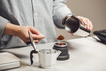 Preparing Geyser Coffee Maker by Filling Cup With Freshly Ground Medium Coffee