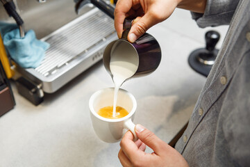 Barista Expertly Pours Steamed Milk Into Espresso to Craft Perfect Cappuccino