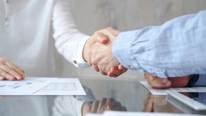 Business people shaking hands over contract agreement and financ